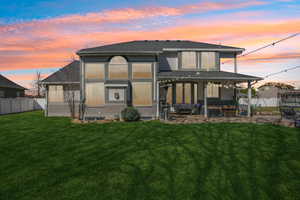 Rear view of house featuring a patio area and a shingled roof