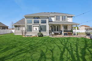 Rear view of house with an outdoor hangout area, a patio, and stucco siding