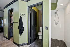 Full bathroom with a stall shower, ornamental molding, connected bathroom, and recessed lighting