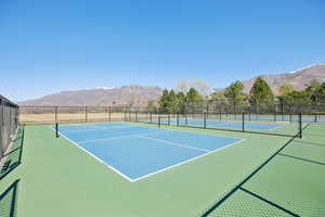 View of tennis court featuring a mountain view