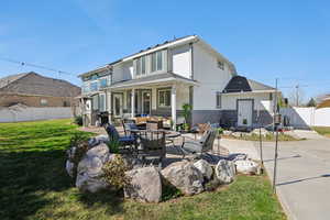 Back of house featuring a fenced backyard, a patio, and an outdoor lounge area