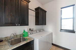 Laundry area featuring washing machine and clothes dryer and cabinet space