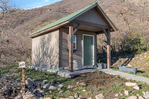 Entrance to property with a metal roof and a mountain view