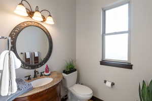 Bathroom featuring vanity and healthy amount of natural light