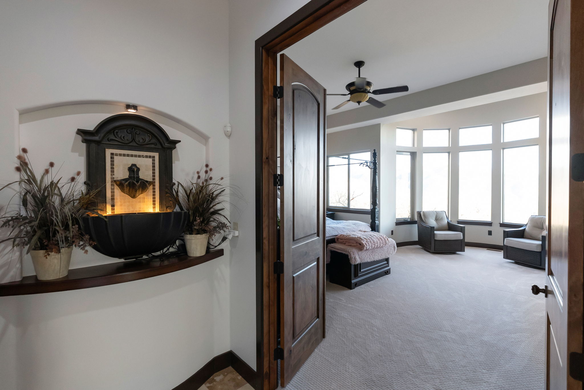 Hallway with light carpet and baseboards