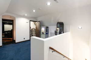 Hallway featuring dark carpet and recessed lighting