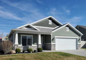 Craftsman-style house featuring a porch, stone siding, an attached garage, and a shingled roof