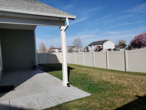 Fenced backyard with a patio area and a residential view