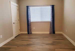 Empty room with wood finished floors and baseboards