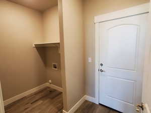 Laundry area with dark wood-style floors and hookup for a washing machine