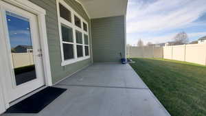 Fenced backyard with a patio