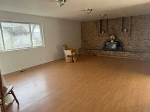 Dinning and family room featuring wood finished floors and a wood stove