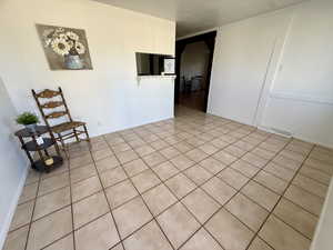 Empty room with tile patterned floors and baseboards