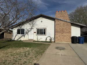 View of front facade featuring a chimney