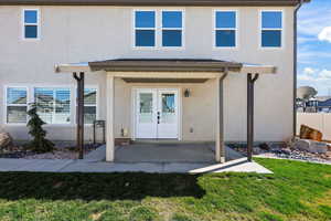 Entrance to property with stucco siding and french doors