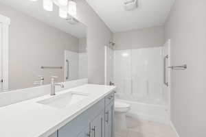 Full bathroom featuring vanity, tub / shower combination, and light tile patterned floors