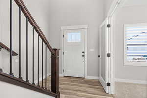 Entrance foyer with stairway and light wood-type flooring