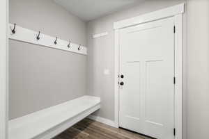 Mudroom with light wood-style flooring and baseboards