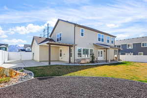 Rear view of house featuring a patio, a fenced backyard, a gate, and stucco siding