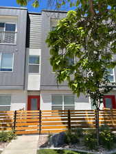 View of building exterior with a fenced front yard
