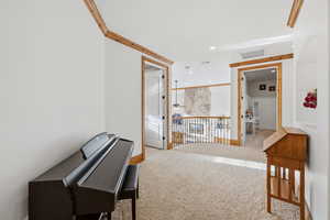 Hall featuring recessed lighting, light carpet, and ornamental molding