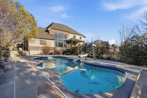 View of swimming pool featuring patio surround