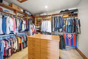 Walk in closet featuring light carpet