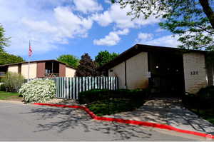 View of side of home featuring a gate
