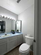Bathroom featuring vanity, light tile patterned flooring, and a textured ceiling