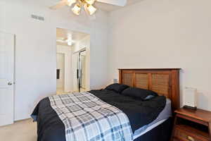 Bedroom with carpet flooring, ensuite bath, a ceiling fan, and a closet
