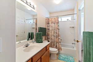 Full bath featuring vanity and shower / bath combination with curtain
