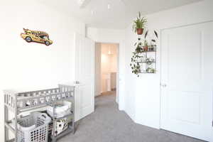 Bedroom with light carpet and baseboards