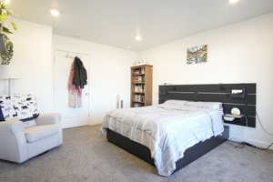 Carpeted bedroom with baseboards and recessed lighting