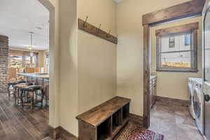 Laundry area featuring washer and dryer and arched walkways