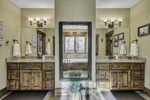 Full bath with a bath and two vanities