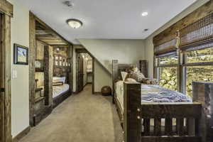 Bedroom featuring baseboards and carpet