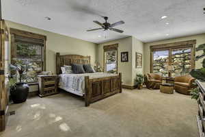 Bedroom with recessed lighting, light colored carpet, a textured ceiling, and ceiling fan