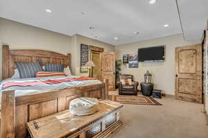 Bedroom with light carpet and recessed lighting