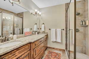 Bathroom with double vanity and a shower stall
