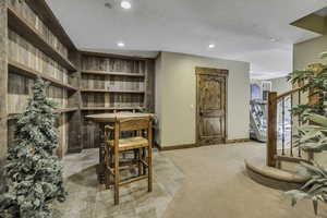 Office with recessed lighting, light carpet, and a textured ceiling