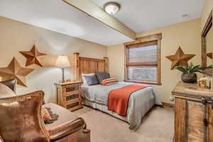 Bedroom featuring light colored carpet and a textured ceiling