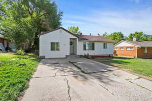 Ranch-style home featuring driveway and a front yard