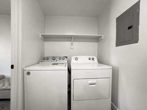 Laundry room with electric panel and independent washer and dryer