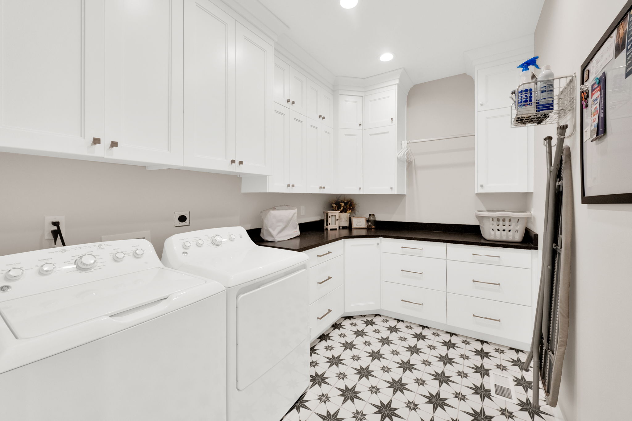 Laundry area featuring recessed lighting, cabinet space, washer and dryer, and light flooring