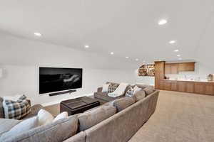 Living area featuring light colored carpet and recessed lighting