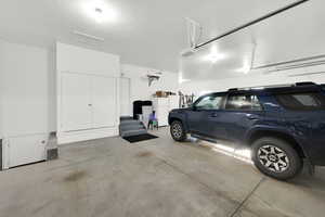 Garage featuring freestanding refrigerator