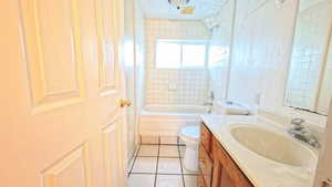 Full bathroom featuring vanity, light tile patterned flooring, and bathtub / shower combination
