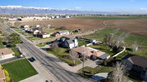 View of rural area with nearby suburban area and a mountain backdrop