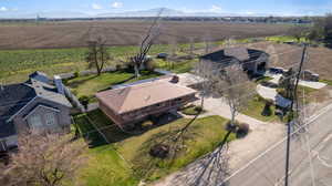 Aerial view of sparsely populated area with farmland and mountains