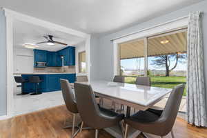 Dining room with light wood-type flooring and ceiling fan
